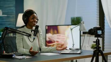 Famous vlogger making online podcast recording for virtual show in front of camera. Influencer using headphones speaking at microphone. On-air production internet broadcast show host streaming photo