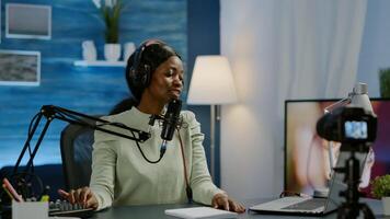 Influencer making online internet content for web subscribers using camera in home podcast studio during livestreaming. On-air online production broadcast show host streaming live content photo