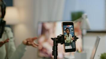 Social media woman talking at professional microphone while recording podcast for youtube channel at smartphone. Creative online show On-air production internet broadcast host streaming live photo