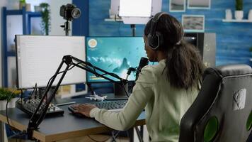 African woman streamer cyber winning performing space shooter game on RGB powerful computer talking with players on stream chat and microphone in gaming competition. Player man streaming photo