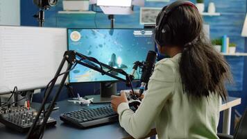 Streamer cyber performing space shooter game holding controller on RGB powerful computer talking with players on stream chat and microphone during professional competition. Player man streaming photo