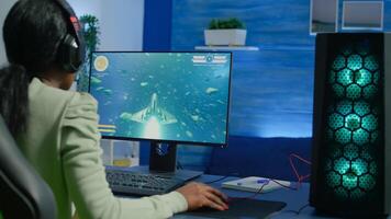 Addicted african gamer performing cyber games using professional headphones in gaming room. Competitive gamer playing space shooter game tournament with new graphics on powerful computer. photo