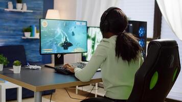 Pro african cyber woman talking with players into headphones and winning games competition. Professional gamer streaming online videogames with new graphics on powerful computer from gaming room photo