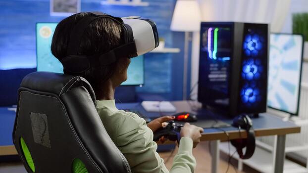 Back view of black woman gamer wearing virtual reality headset playing with joystick space shooter videogames on online tournement. Defeated player using wireless controller for online competition photo