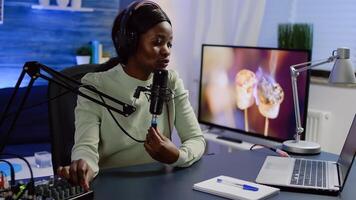 Social media vlogger speaking with followers on online podcast using professional microphone and headset. Influencer talking during livestreaming, blogger discussing in broadcast wearing headphones. photo