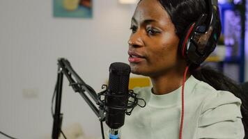 Black vlogger on air during podcast channel using mixer checking sound and professional microphone. Online show production internet broadcast host streaming live , recording social media content photo