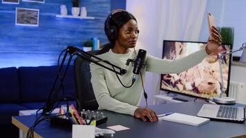 Influencer doing vlog production with professional smartphone in home studio. Online show On-air production internet broadcast host streaming live content, recording digital social media communication photo
