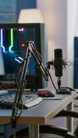 Empty streaming studio with RGB led lights powerful personal computer for gaming online competition. Display with stream chat prepared for virtual tournament, living room with nobody in photo