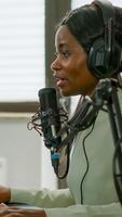 Sad black woman gamer with headphone streaming videogames in gaming home studio losing competition. Professional player talking with other players online for game playing on powerful computer photo