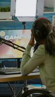African streamer regrets losing live space shooter game tournament touching temple, chatting with team. Professional gamer streaming online games with new graphics on powerful computer. photo