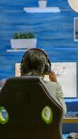 Angry african pro woman gamer losing space shooter videogame during online championship. Cyber player testing virtual games using powerful personal computer in gaming room during esports tournament photo