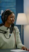 Influencer making online internet content for web subscribers using camera in home podcast studio during livestreaming. On-air online production broadcast show host streaming live content photo