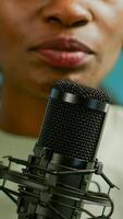 Close up of famous woman recording a vlog for subscribers using podcast microphone for vlogging. On-air online production internet broadcast show host streaming live content for social media photo