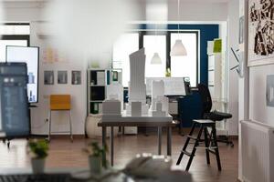 Empty room for architectural design and plan building model maquette. Professional workplace with blueprints computer equipment notepad sketch board for architect occupation. photo