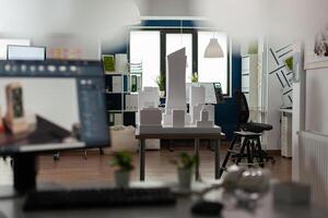 Empty architectural room for design and modern computer with blueprint plan building model maquette. Workplace for professional architect occupation with business equipment desk board photo