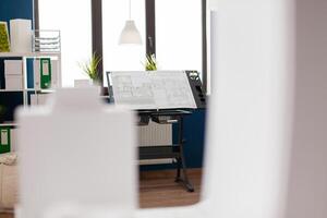 Architectural design board with blueprints for real estate development in modern architect open space office. Stand with drawing plans for urban planning building complex . photo