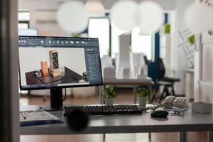 Closeup of modern architect desk with workstation showing 3d blueprints of architectural building complex. Desktop screen showing model of urban planning architecture construction plan. photo