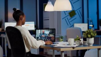 African manager with headphones waving at camera talking with remote disabled employee, overworking using laptop. Woman working in start up financial company havig online meeting, virtual discussing photo