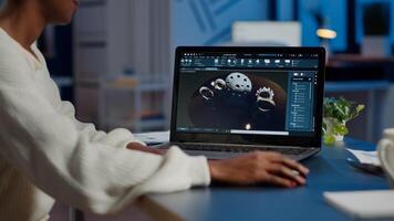 African woman engineer working at new project using laptop doing overtime at night sitting at desk in start-up office. Industrial construction designer studying on pc showing cad software in midnight photo