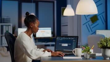 African woman engineer working in modern cad program with gear sitting at desk in start-up business office. Industrial employee studying prototype idea on laptop showing cad software on device display photo