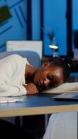 Exhausted overload african business woman falling asleep on desk with open laptop monitor while working in start up company. Overworked employee using doing overtime respecting deadline, sleeping photo