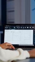 African engineer constructor designer architect analysing new bluilding plan in CAD program working in business office. Industrial woman employee studying prototype idea showing cad software on device display photo