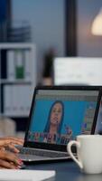 Black woman photo retoucher working on laptop at new project in business office overtime. Content creator doing portrait retouching, artist, occupation, screen, graphic late at night
