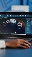 African woman engineer working at new project using laptop doing overtime at night sitting at desk in start-up office. Industrial construction designer studying on pc showing cad software in midnight photo