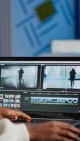 African videographer working at laptop from business office, editing and audio footage at night. Content creator using professional device modern technology network wireless processing film montage. photo