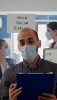 Pov of businessman in face mask to avoid infection talking on online call conference duting zoom meeting. Entrepreneur working safety in new normal office photo