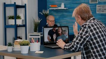 Middle aged woman talking conference with children calling on laptop. Senior old distance mother communicating in online virtual chat remote meeting looking at computer sitting at home. photo