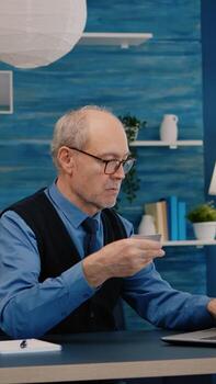 retirado hombre haciendo en línea pago utilizando crédito tarjeta en ordenador portátil trabajando desde hogar. mayor persona compras en línea, pago facturas, haciendo comercio electrónico actas utilizando moderno tecnología vía Internet foto