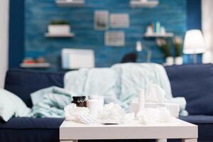 Empty room with medical treatment napkins and pills against cold flu virus disease illness. Bottles with medicine and drugs lying on the table in the bedroom photo