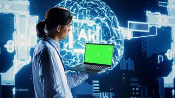 Programmer using chroma key laptop to implement artificial intelligence parallel processing. Admin working on green screen device, enabling AI systems to process machine learning data photo