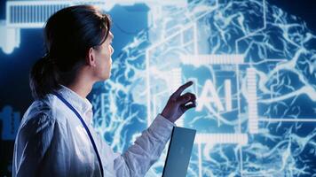 Tech support man developing artificial intelligence neural networks architecture inspired by human brain. Precise IT contractor setting up AI machine learning algorithms in high tech startup photo