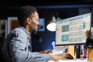 Expert in finance reads funding distribution details from records before building strategy on expenditures and profits. Auditing operations handled by legal professional, financial planning. photo