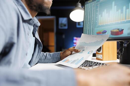 African american advisor reviewing legal balance documents at workstation, examining capital funds statistics for monthly accounting analysis. Banking expert evaluating company budget. Close up. photo