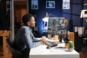 Resources manager attends videocall meeting with employees, working from home and giving them advice about executive duties. African american man chatting with his team on webinar call. photo