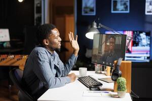 Instructor conducting videoconference training session with newly hired worker, teaching him corporate duties and procedures. Web remote working, trainer and trainee debate their position. photo