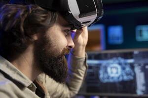 Cheerful admin using VR headset to chat with sentient artificial intelligence with own autonomy. Close up of smiling man at home talking with conscious AI superintelligence using virtual reality tech photo