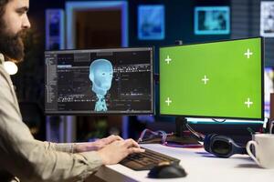Isolated screen monitor used by software engineer at home to upload consciousness into computer. IT professional in apartment creating link between brain and chroma key PC photo