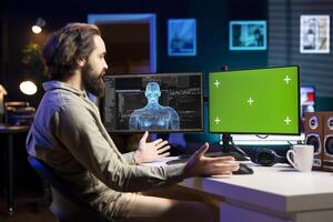 Software developer unable to believe eyes after seeing AI gaining humanoid form on green screen monitor. Computer scientist surprised by artificial intelligence materializing on chroma key display photo