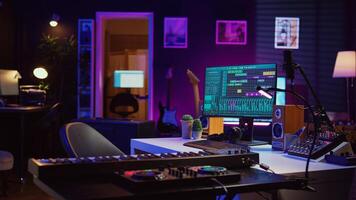 Creative space used at recording songs and tunes with daw software, various electronic equipment and tools for mix and master performance. Empty home studio with mixing panel and amplifier. Camera B. photo