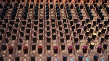Control room panel board with buttons and switchers serve as mechanical and technical equipment of recording and mixing sound. Empty professional soundproof music studio. photo