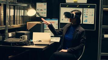 Law enforcement agent works with virtual reality glasses in incident room, reenacting crime timeline with artificial intelligence innovation. Officer uses visual interactive vr headset. Camera A. photo