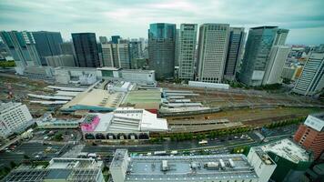 A timelapse of panoramic view in front of the station in Tokyo cloudy wide shot tilt video