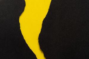 Yellow Background with Torn Black Paper photo