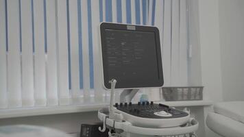 Modern sonography ultrasound device is in specialists office before medical examination of patient in private medical practice. Checking diseases of human internal organs. Empty room, no one there. video