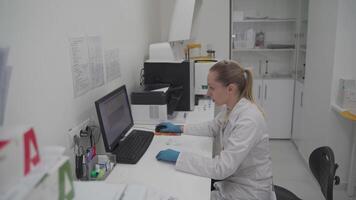 Woman scientist biotechnologist working on computer research in development lab. Chemical research technology in the scientific medicine laboratory develops and develops a new type of vaccine. video