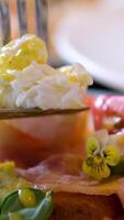 Eggs Benedict on toasted muffins with ham and sauce Prick microgreens with a fork and poached egg Benedict. Egg benedict with hollandaise sauce and smoked salmon on toast video